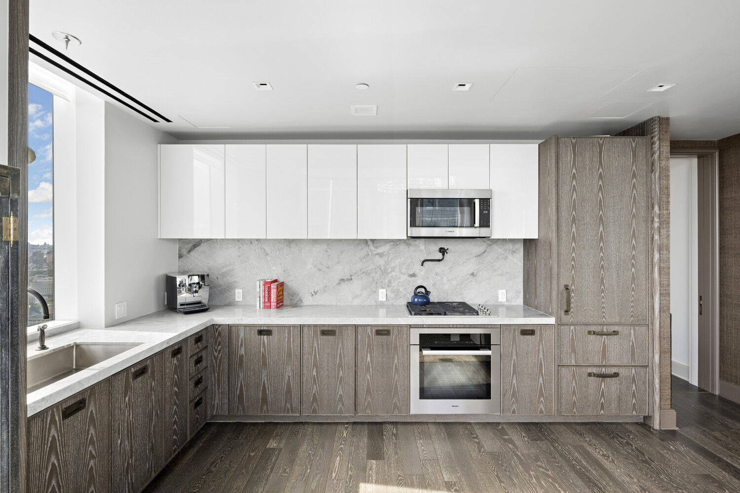 45 East 22nd Street, Unit 37B Manhattan, NY 10010 - Photo 6 of 13 a kitchen with a sink stove top oven and cabinets