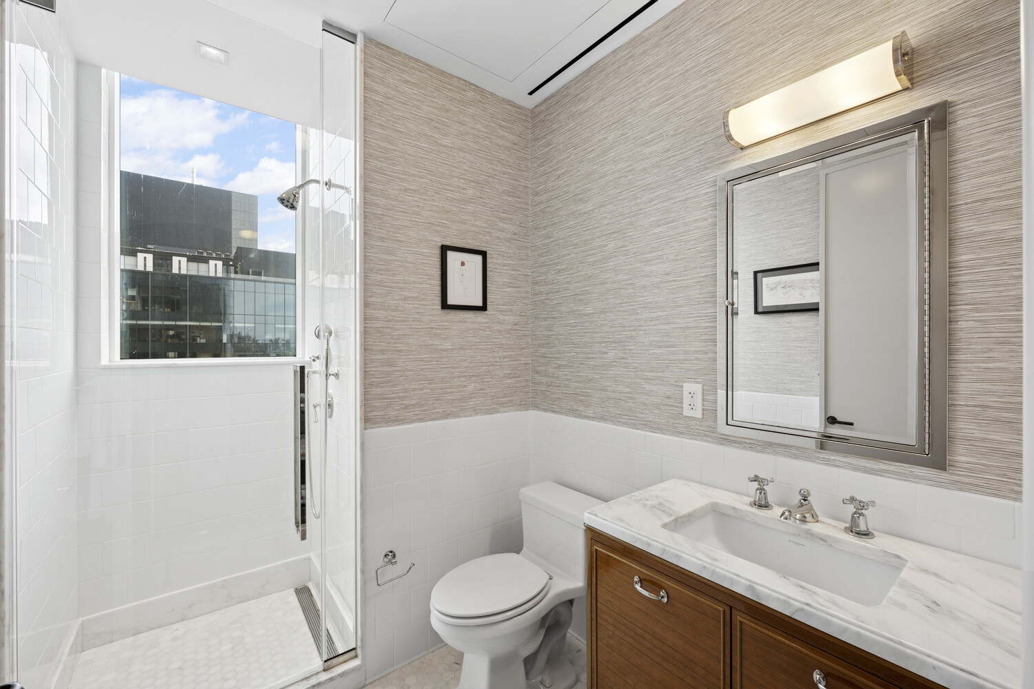 45 East 22nd Street, Unit 37B Manhattan, NY 10010 - Photo 8 of 13 a bathroom with a sink a toilet a mirror and shower