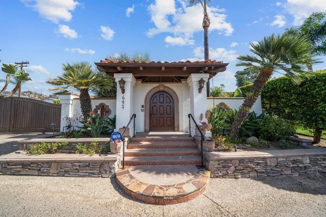 a view of a backyard with couches and a table and chairs