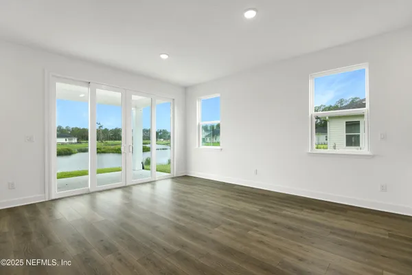 a view of room with window and wooden floor