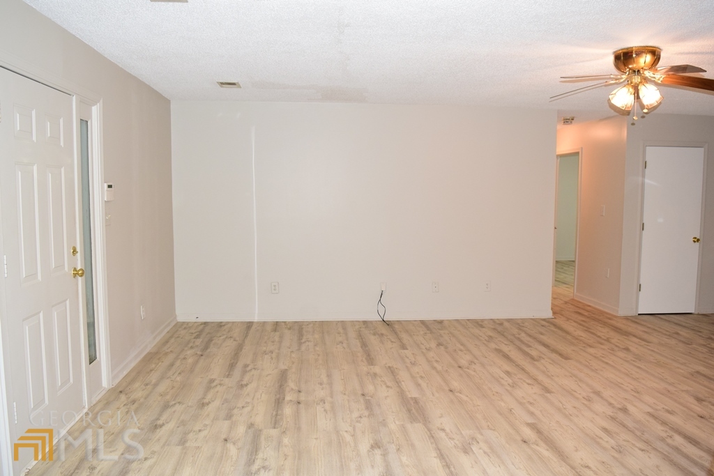 672 Andrew Bailey Road Sharpsburg, GA 30277 - Photo 11 of 34 a view of empty room with wooden floor and fan