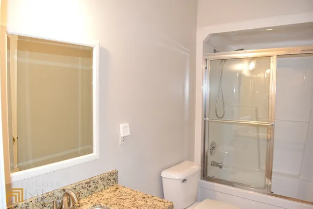 a bathroom with a shower and a toilet