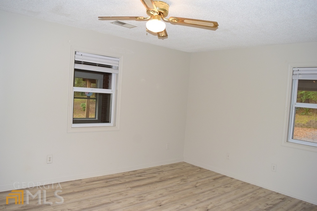 672 Andrew Bailey Road Sharpsburg, GA 30277 - Photo 18 of 34 an empty room with windows and fan