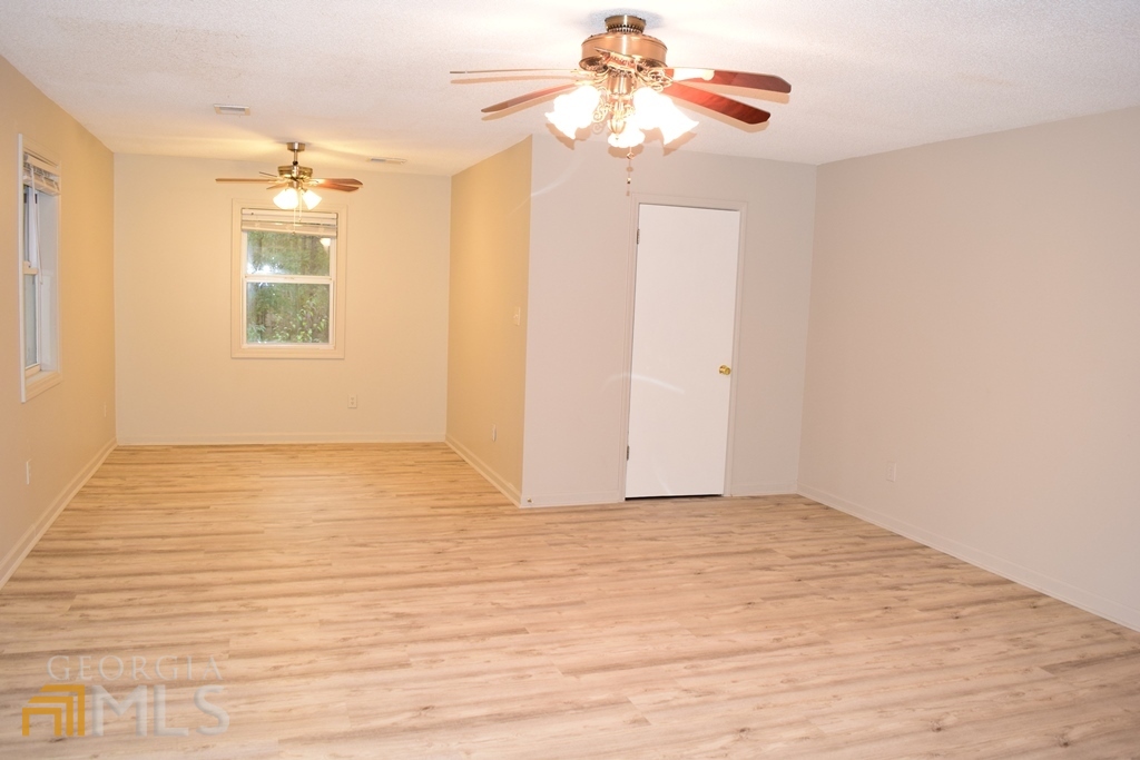 672 Andrew Bailey Road Sharpsburg, GA 30277 - Photo 20 of 34 a view of an empty room with window and a kitchen