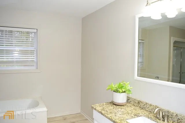 a white vase with flowers sitting on a table