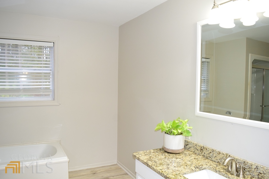 672 Andrew Bailey Road Sharpsburg, GA 30277 - Photo 21 of 34 a white vase with flowers sitting on a table