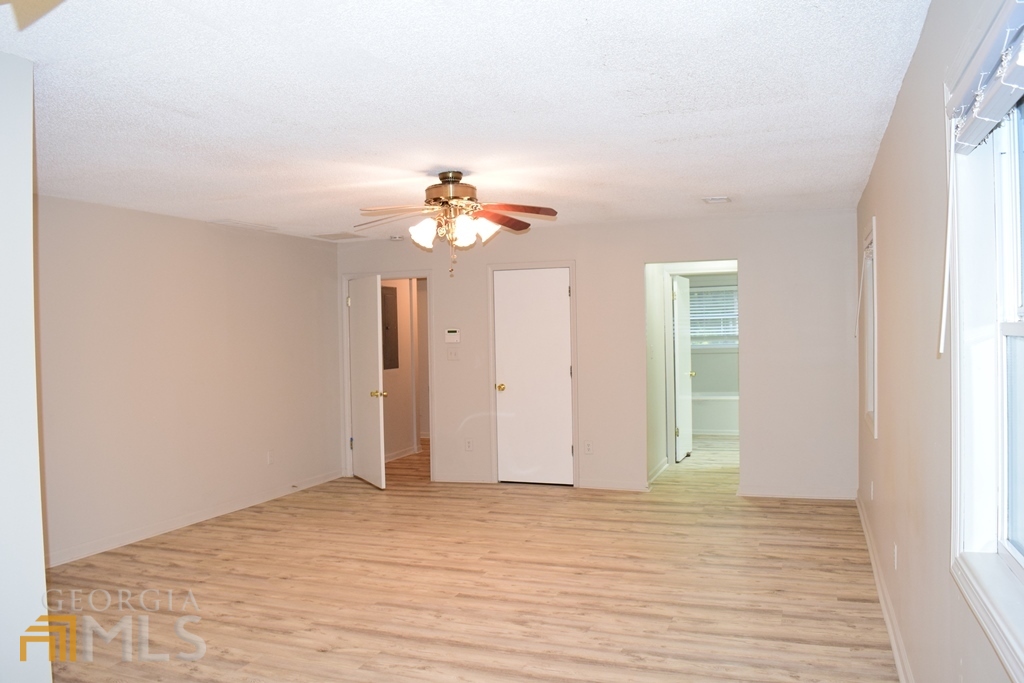 672 Andrew Bailey Road Sharpsburg, GA 30277 - Photo 24 of 34 a view of empty room with wooden floor and fan