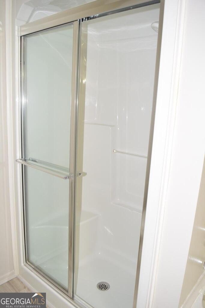 672 Andrew Bailey Road Sharpsburg, GA 30277 - Photo 26 of 34 a bathroom with a glass shower door