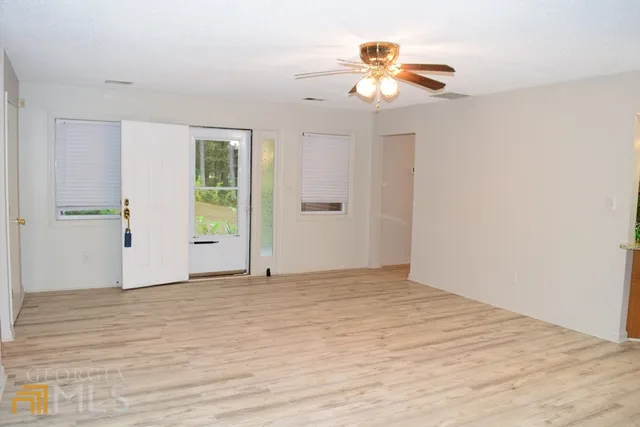 wooden floor in an empty room with a window