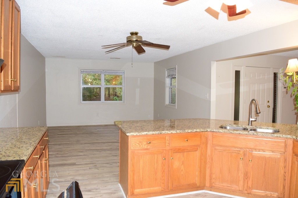 672 Andrew Bailey Road Sharpsburg, GA 30277 - Photo 8 of 34 a bathroom with a granite countertop sink and a mirror