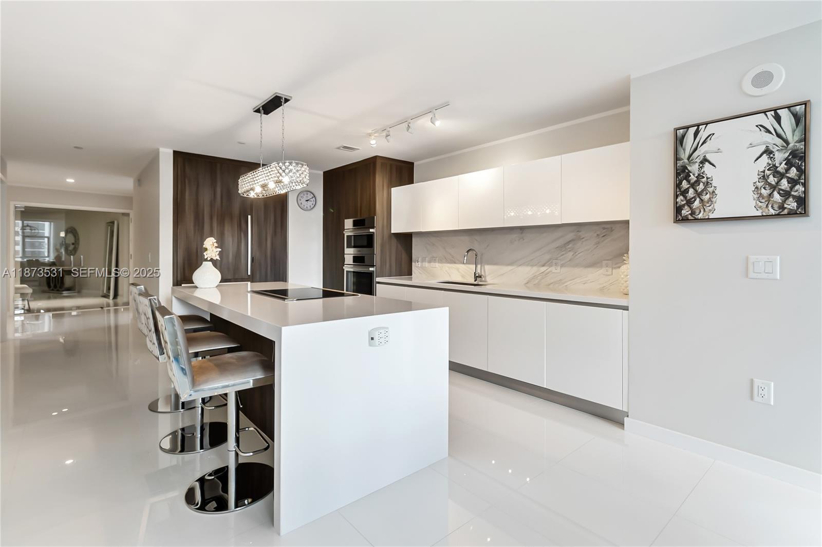851 Northeast 1st Avenue, Unit 1611 Miami, FL 33132 - Photo 6 of 47 a kitchen with a sink a stove and chairs