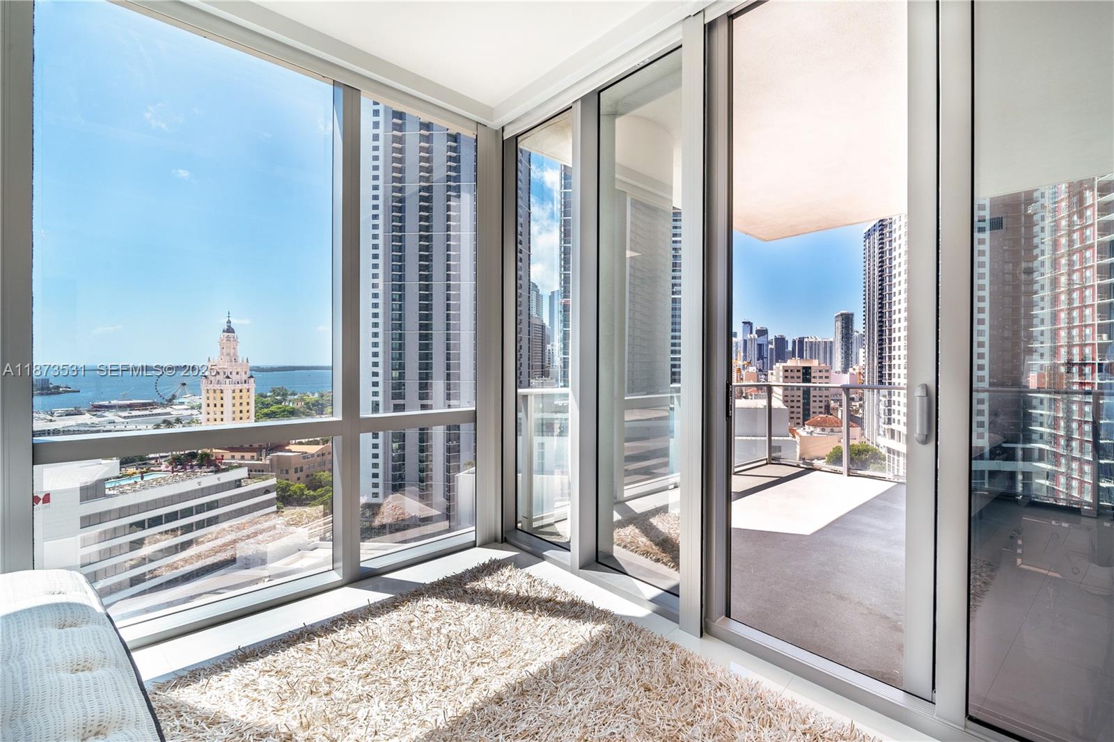 851 Northeast 1st Avenue, Unit 1611 Miami, FL 33132 - Photo 10 of 47 a view of a living room and floor to ceiling window