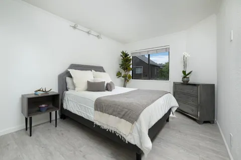 a spacious bedroom with a bed and window