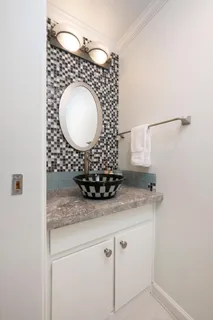 a bathroom with a granite countertop sink a mirror and vanity