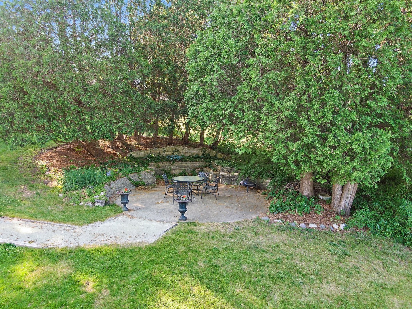 804 Murray Road Tower Lakes, IL 60010 - Photo 30 of 44 a view of a backyard with a bench and a fire pit