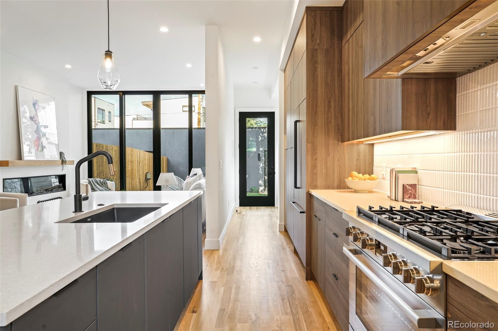 4449 Stuart Street Denver, CO 80212 - Photo 11 of 44 a view of a kitchen with a sink and wooden floor