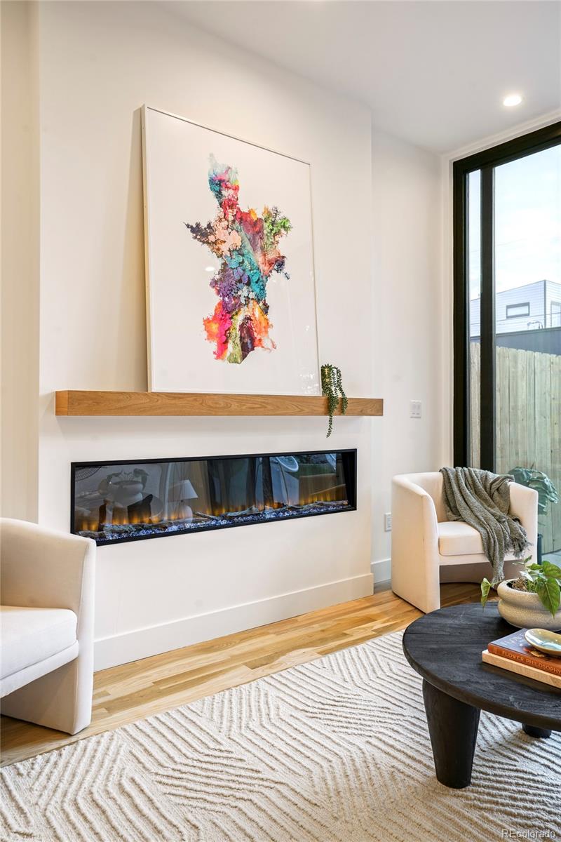 4449 Stuart Street Denver, CO 80212 - Photo 14 of 44 a living room with furniture and a fireplace