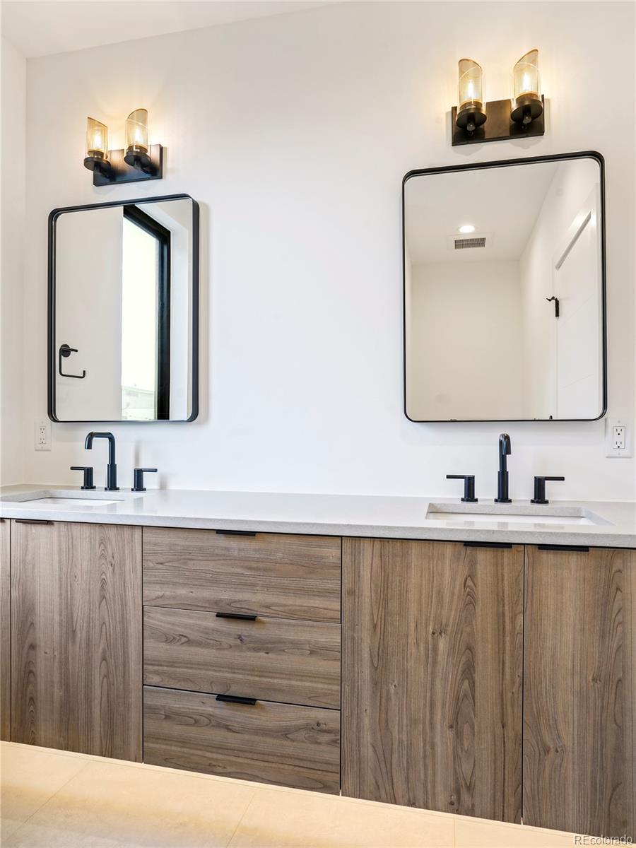 4449 Stuart Street Denver, CO 80212 - Photo 18 of 44 a bathroom with a sink vanity and mirror