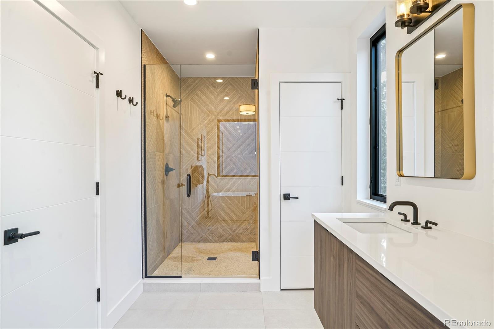 4449 Stuart Street Denver, CO 80212 - Photo 24 of 44 a bathroom with a double vanity sink and mirror with shower