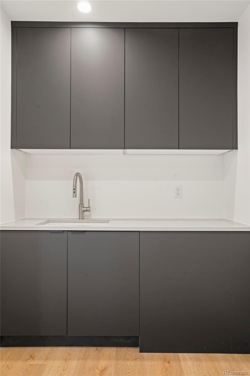 4449 Stuart Street Denver, CO 80212 - Photo 26 of 44 a bathroom with a sink and mirror