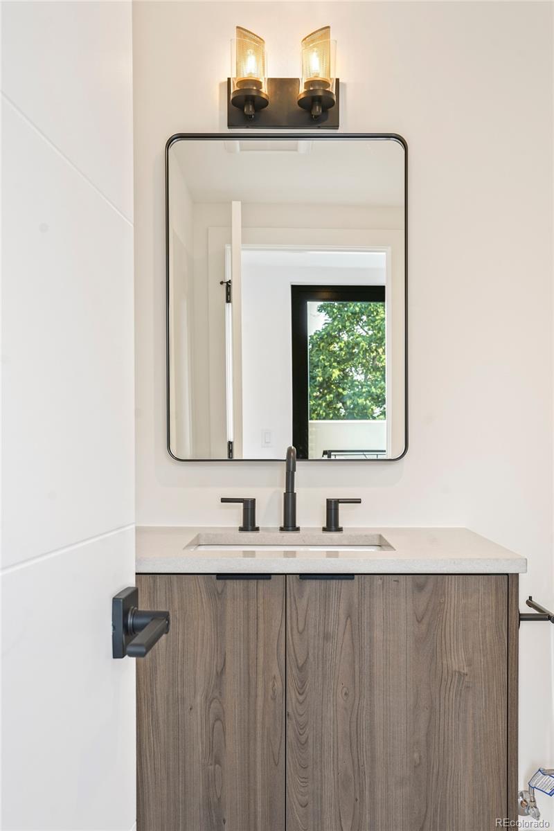 4449 Stuart Street Denver, CO 80212 - Photo 30 of 44 a bathroom with a sink and a mirror
