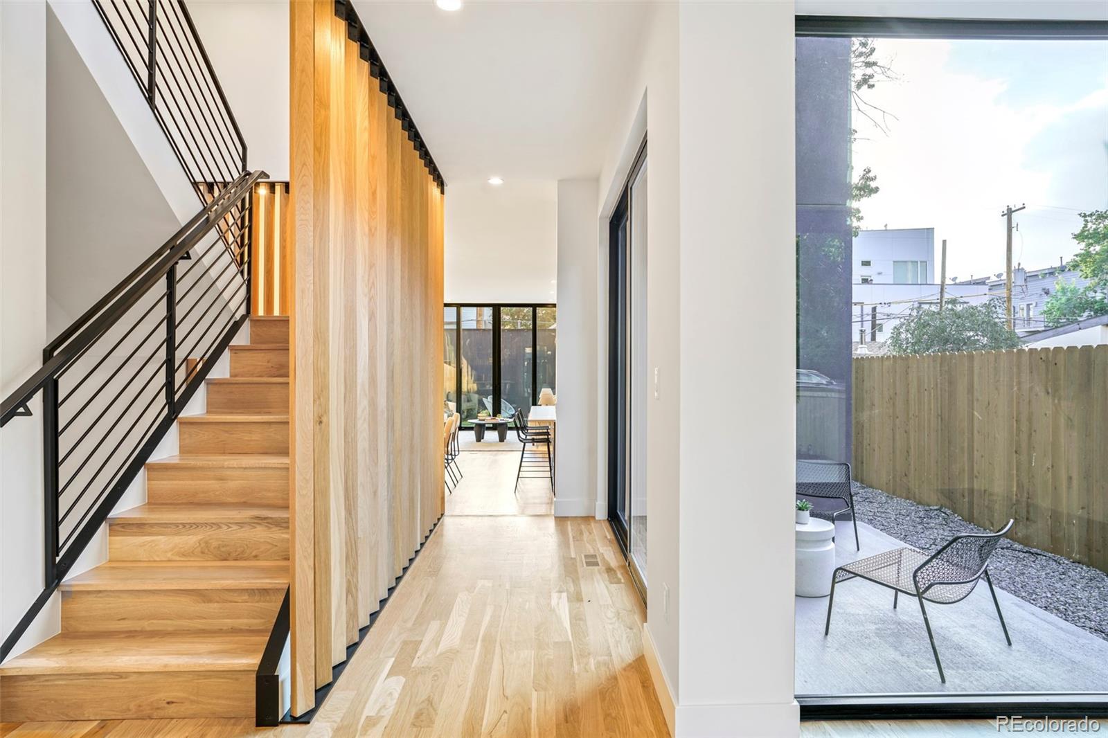 4449 Stuart Street Denver, CO 80212 - Photo 3 of 44 a view of a hallway with wooden floor and staircase