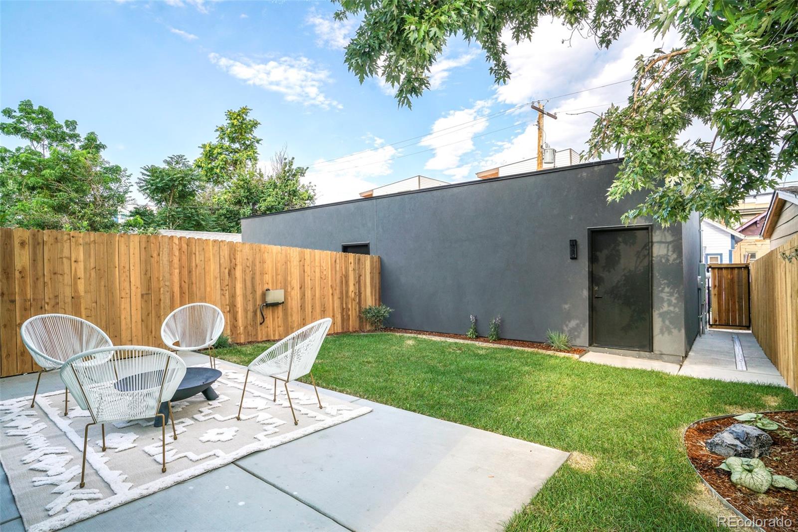 4449 Stuart Street Denver, CO 80212 - Photo 35 of 44 a view of a chairs and table in backyard of the house
