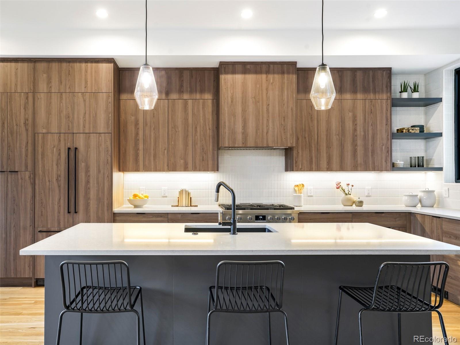 4449 Stuart Street Denver, CO 80212 - Photo 9 of 44 a kitchen with a sink a counter space appliances and cabinets