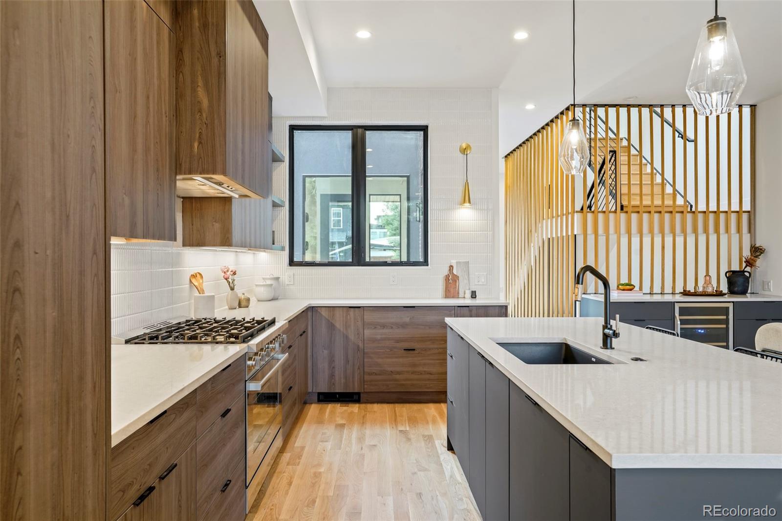 4449 Stuart Street Denver, CO 80212 - Photo 10 of 44 a kitchen with stainless steel appliances a sink stove and cabinets