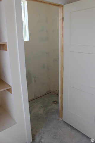 4933 East Remington Road Cedar City, UT 84721 - Photo 22 of 33 Utility space featuring a window, concrete flooring with a floor drain, and a white paneled door