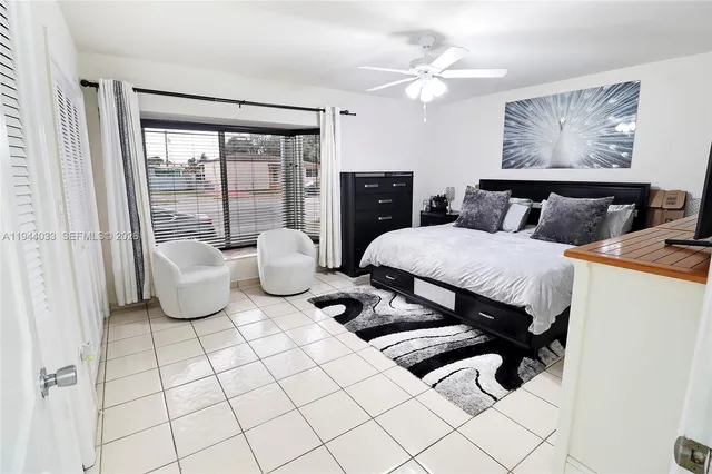 a view of a patio with table and chairs potted plants and a palm tree