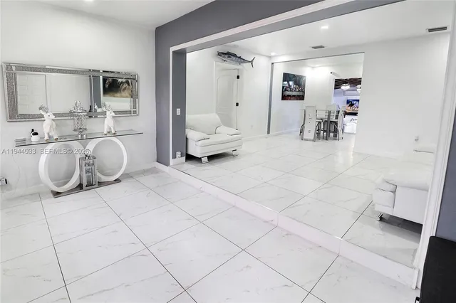 a kitchen with stainless steel appliances a stove a sink and a refrigerator