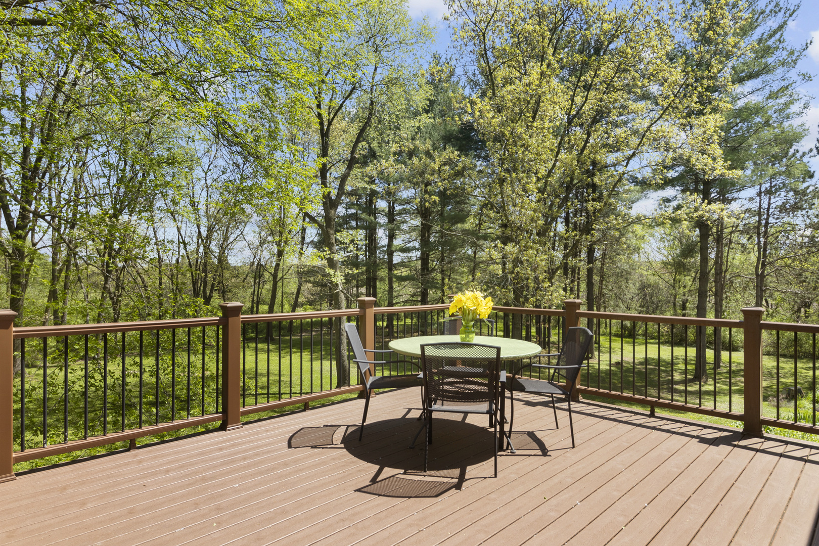 8518 Reese Road Harvard, IL 60033 - Photo 19 of 34 a view of a balcony with wooden floor and outdoor seating