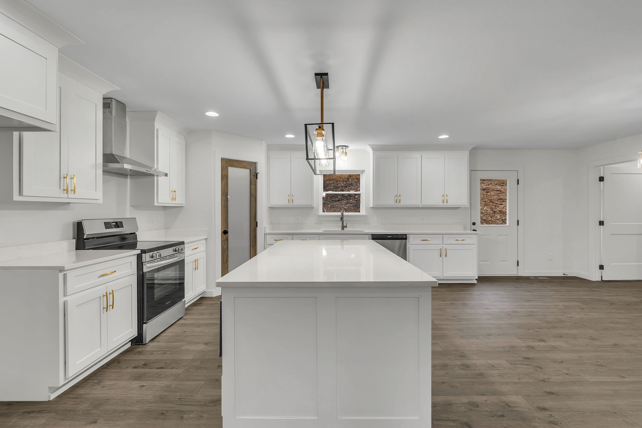 500 Difficult Road Pleasant Shade, TN 37145 - Photo 13 of 40 a kitchen with white cabinets and stainless steel appliances