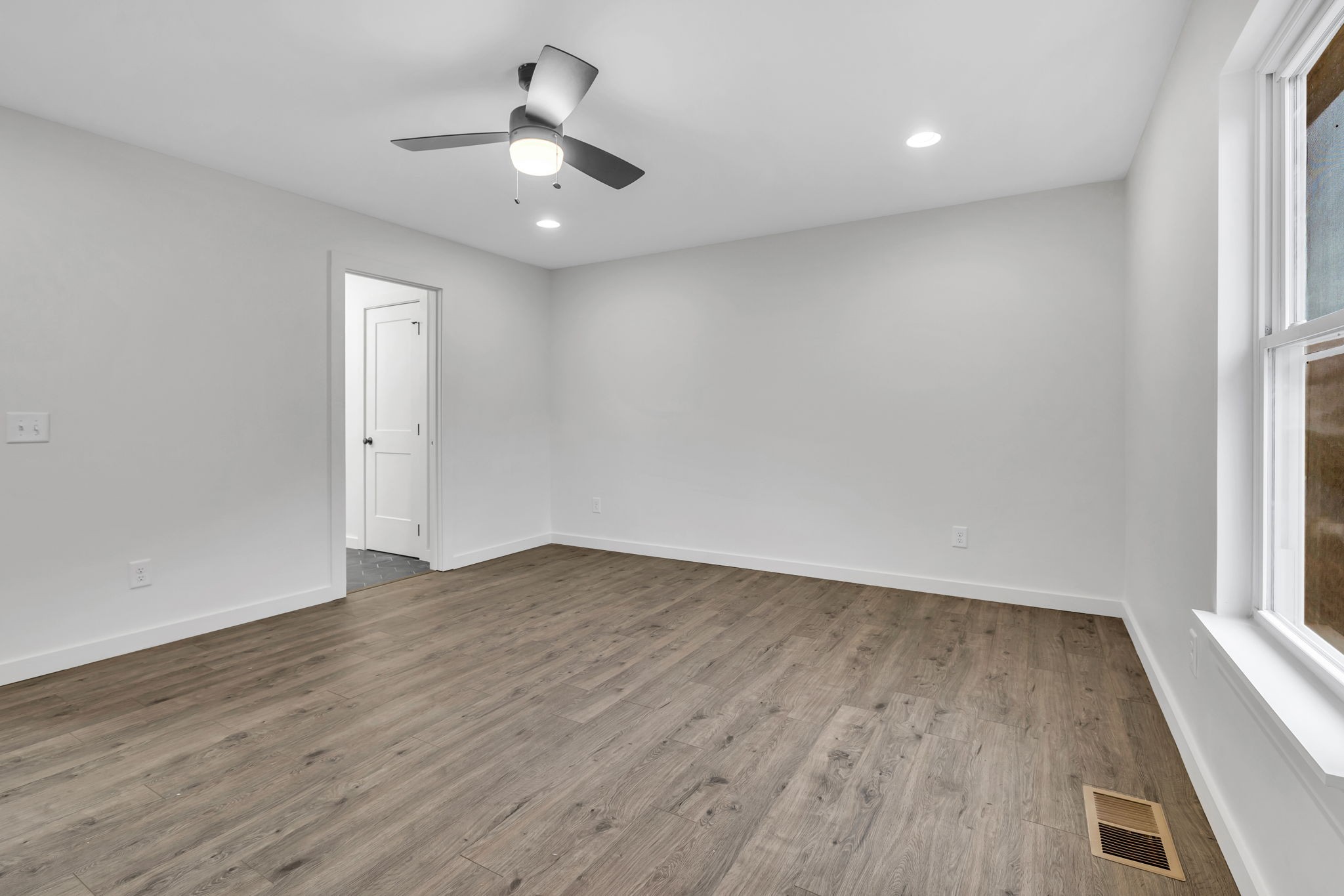 500 Difficult Road Pleasant Shade, TN 37145 - Photo 16 of 40 an empty room with wooden floor and windows