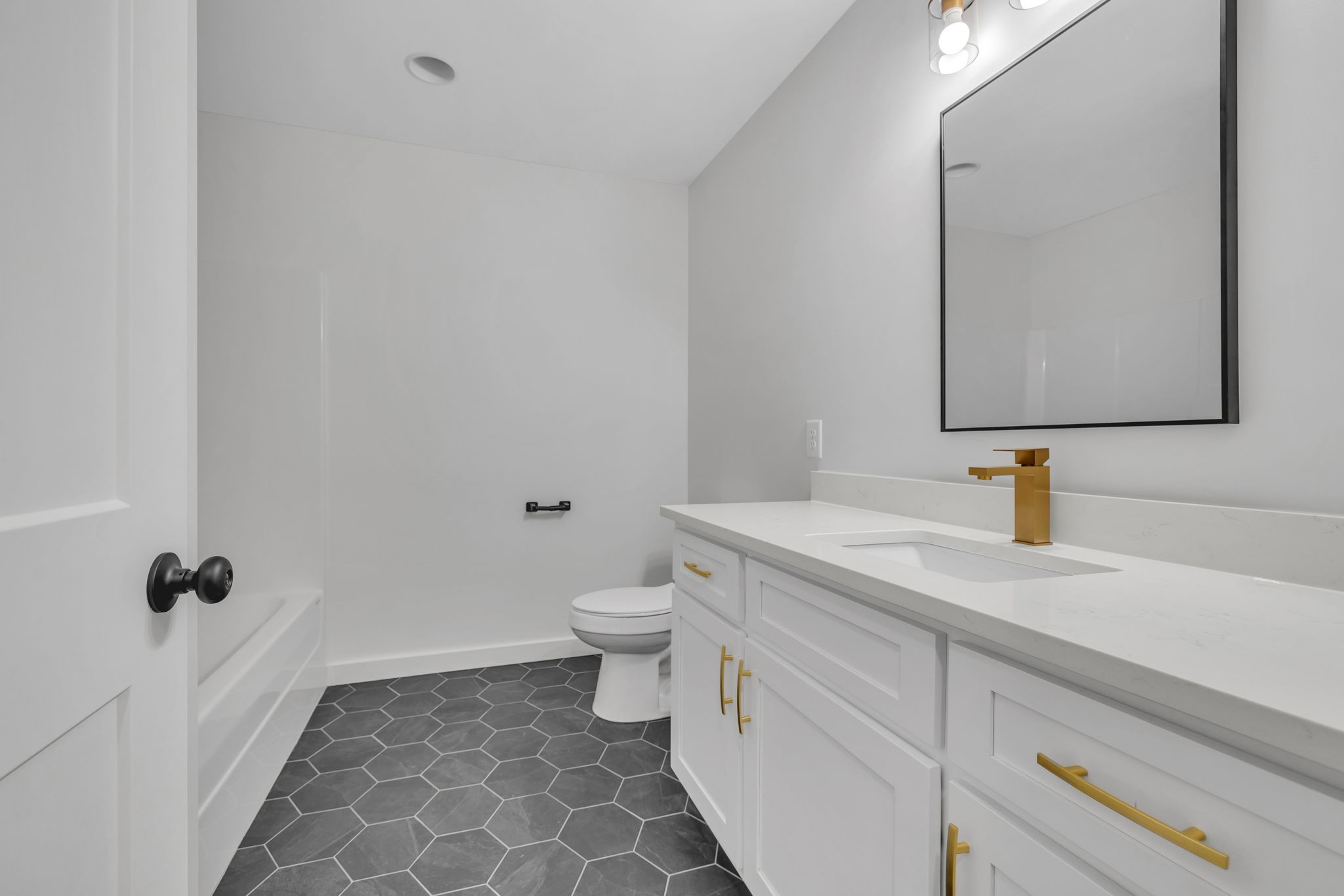 500 Difficult Road Pleasant Shade, TN 37145 - Photo 25 of 40 a bathroom with a granite countertop sink a toilet and a mirror