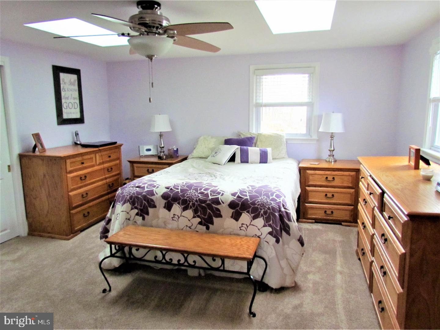 21 Woodside Road Perkasie, PA 18944 - Photo 11 of 25 a bedroom with a bed and a chandelier