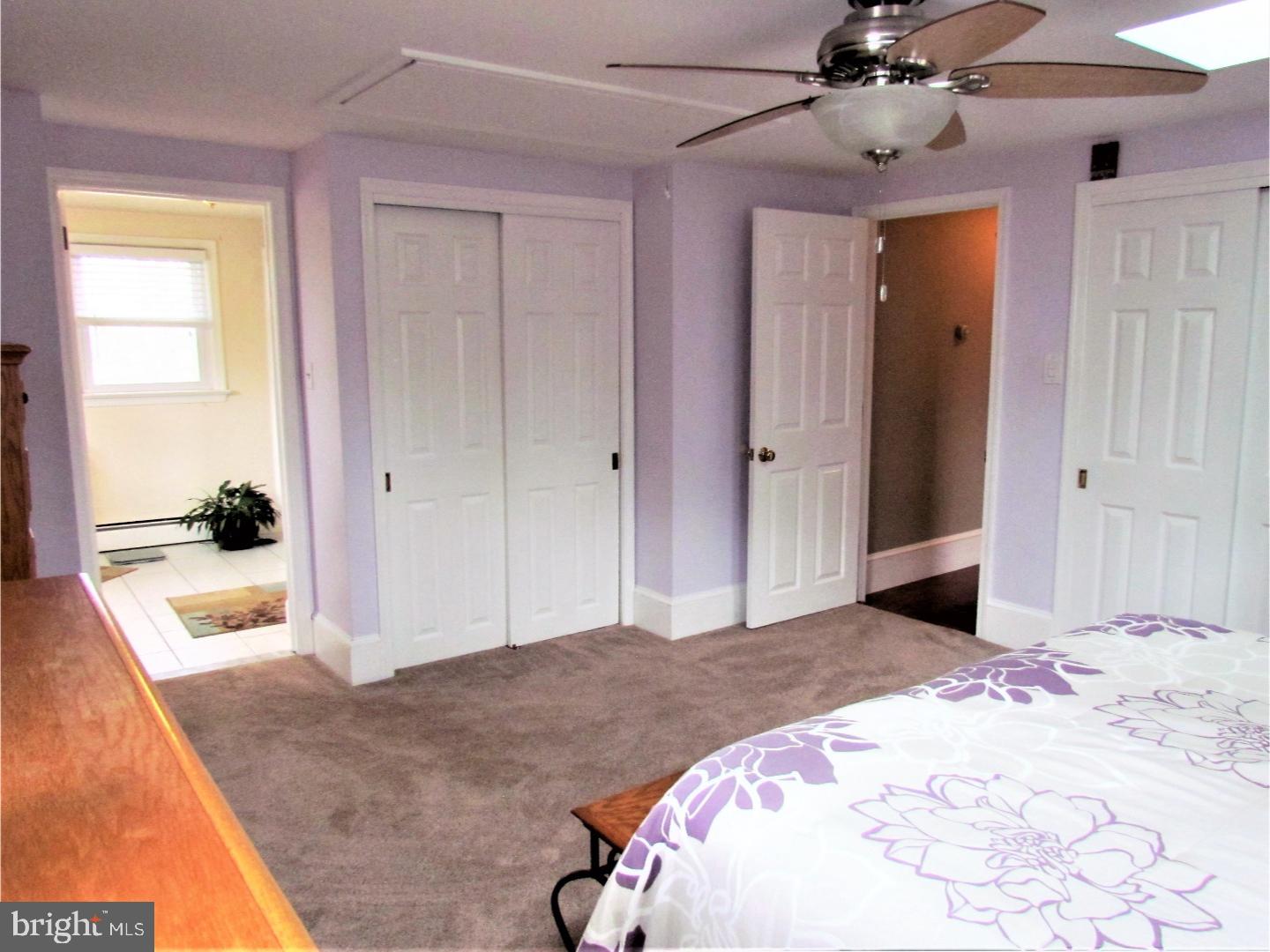 21 Woodside Road Perkasie, PA 18944 - Photo 12 of 25 a bedroom with a bed and a chandelier