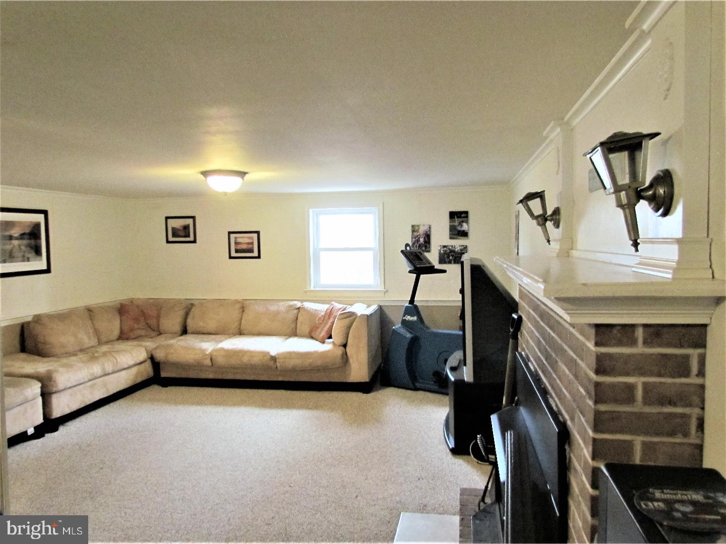 21 Woodside Road Perkasie, PA 18944 - Photo 17 of 25 a living room with furniture and a flat screen tv