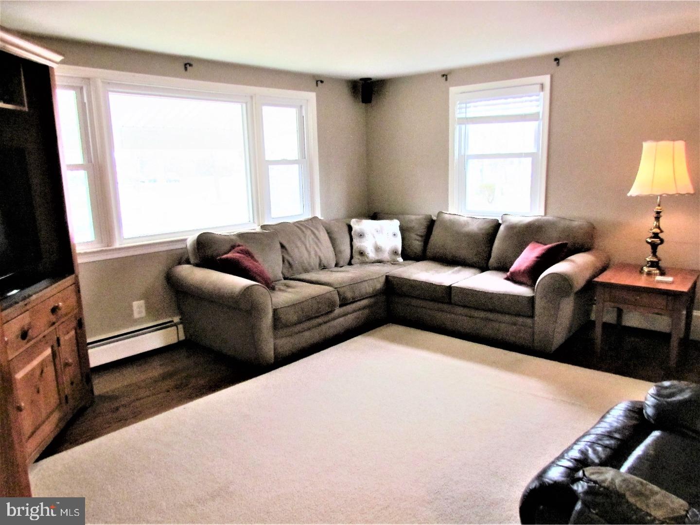 21 Woodside Road Perkasie, PA 18944 - Photo 4 of 25 a living room with furniture flat screen tv and a window