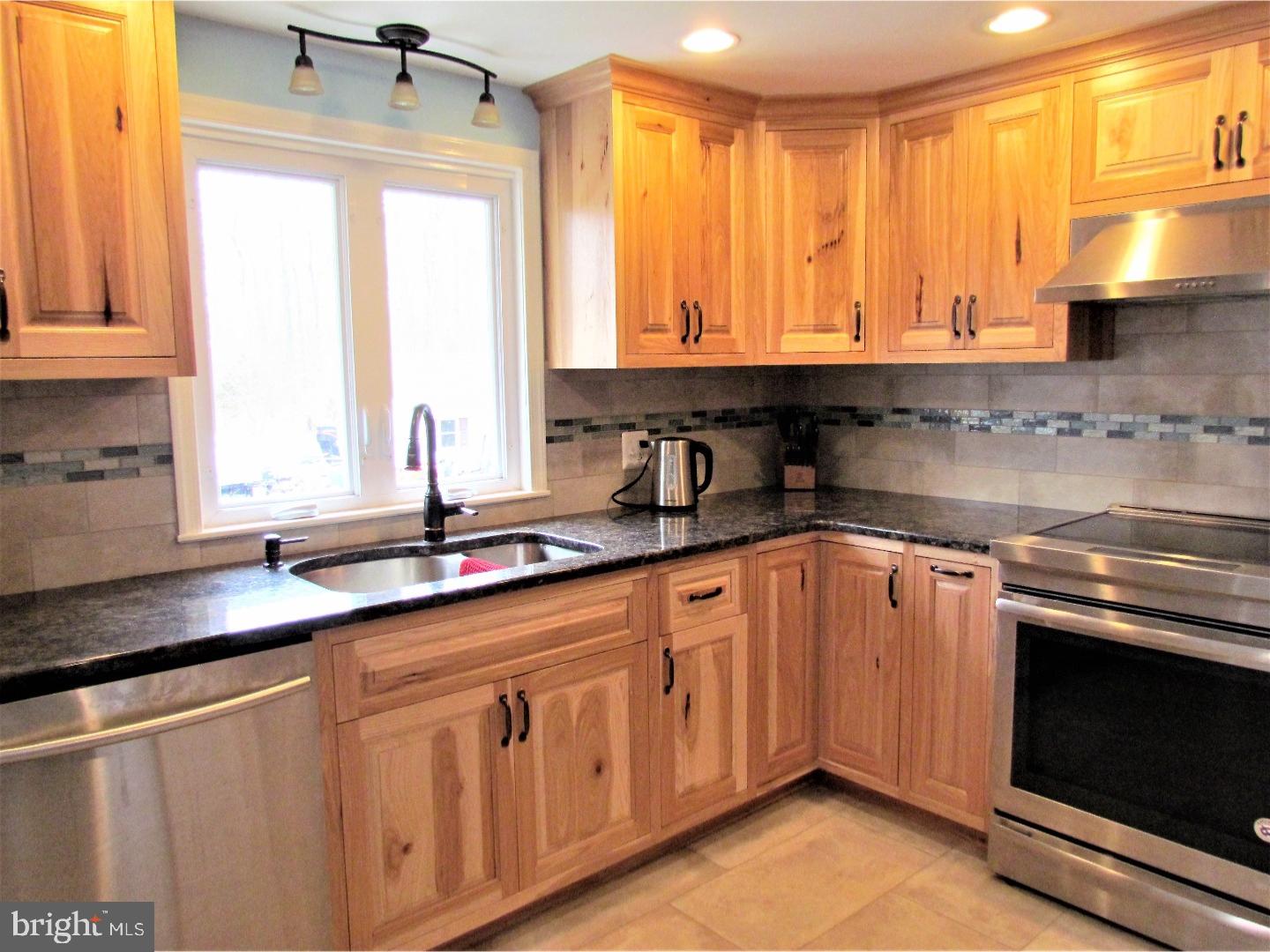21 Woodside Road Perkasie, PA 18944 - Photo 7 of 25 a kitchen with stainless steel appliances granite countertop a sink a stove and cabinets