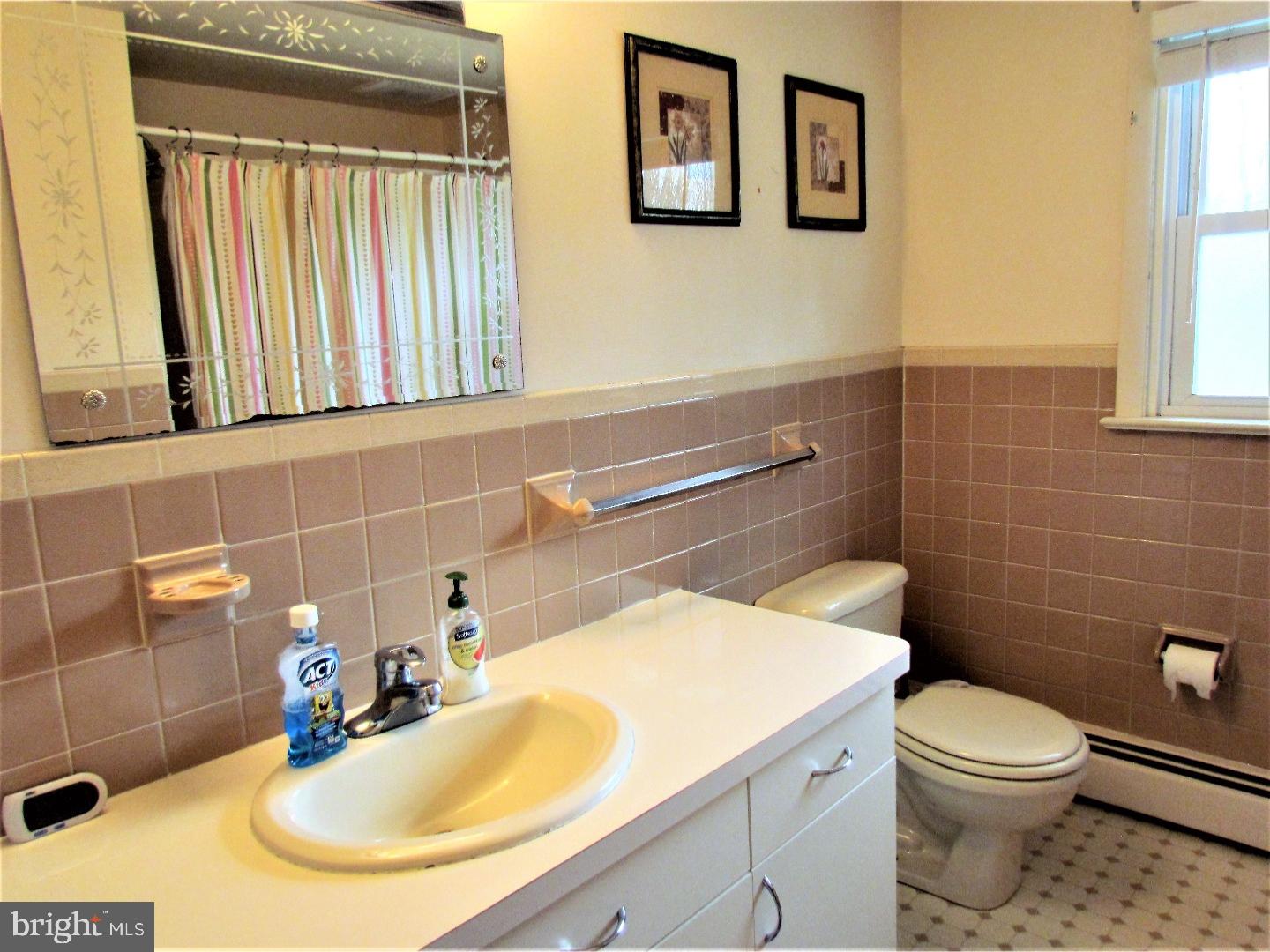 21 Woodside Road Perkasie, PA 18944 - Photo 9 of 25 a bathroom with a sink a toilet and mirror