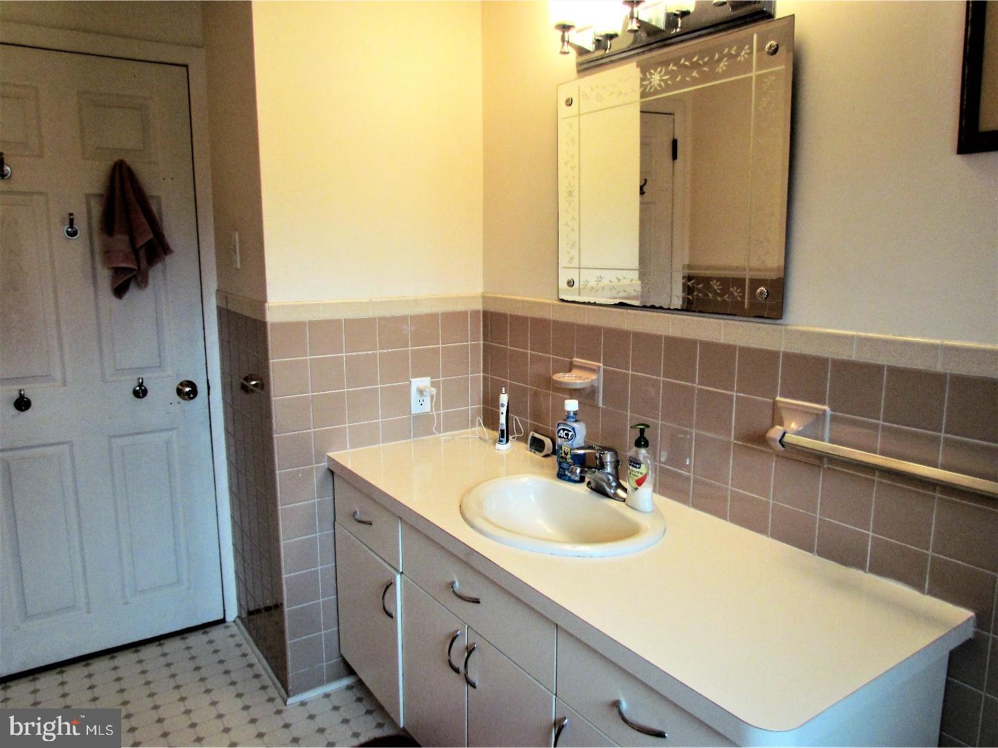 21 Woodside Road Perkasie, PA 18944 - Photo 10 of 25 a bathroom with a sink and a mirror