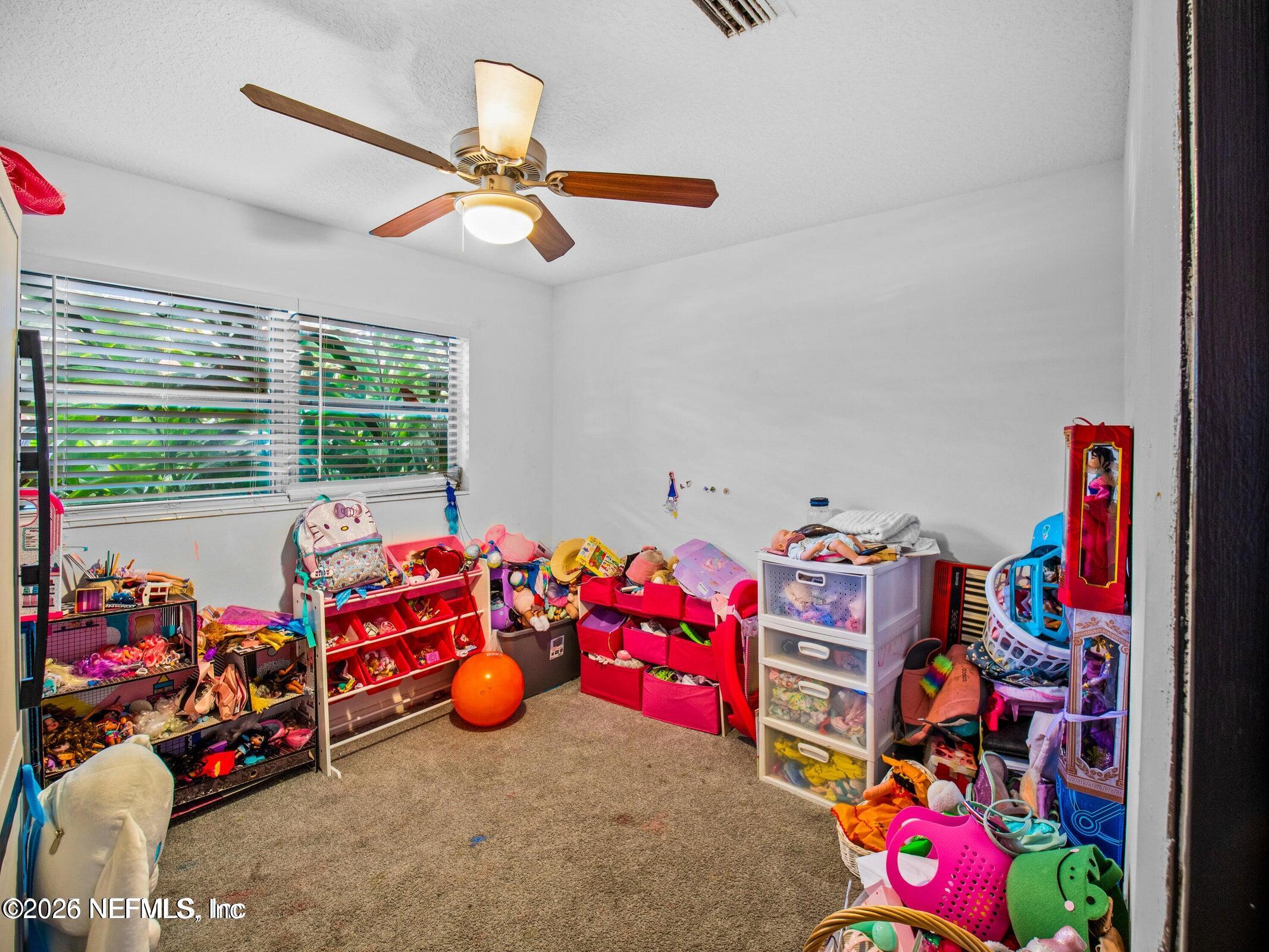 856 Palermo Road Jacksonville, FL 32216 - Photo 11 of 17 a bedroom with lots of baby toys and a chandelier