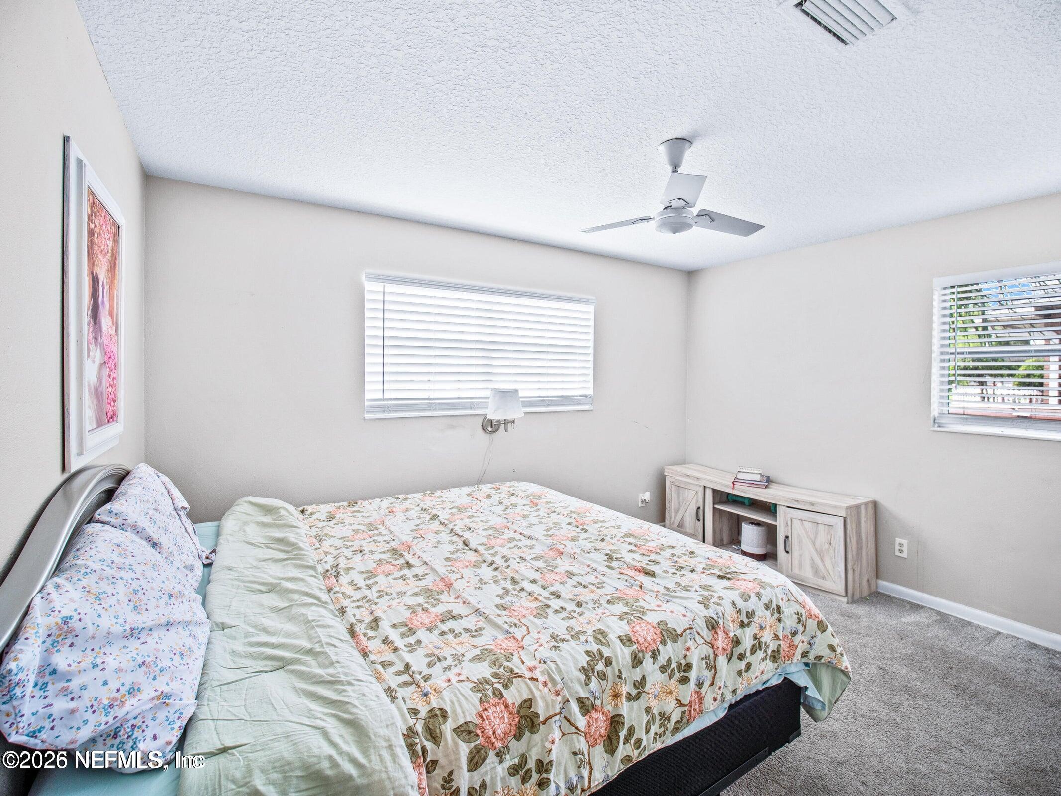 856 Palermo Road Jacksonville, FL 32216 - Photo 13 of 17 a bedroom with a large bed and a window