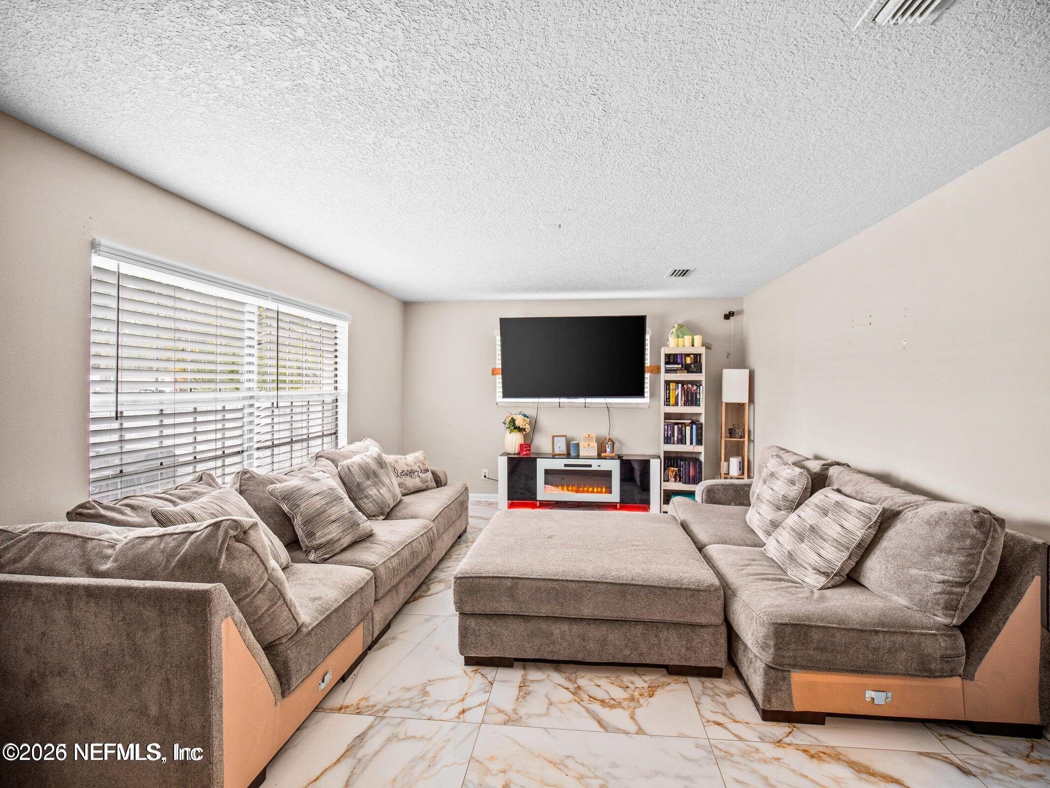 856 Palermo Road Jacksonville, FL 32216 - Photo 14 of 17 a living room with furniture and a flat screen tv