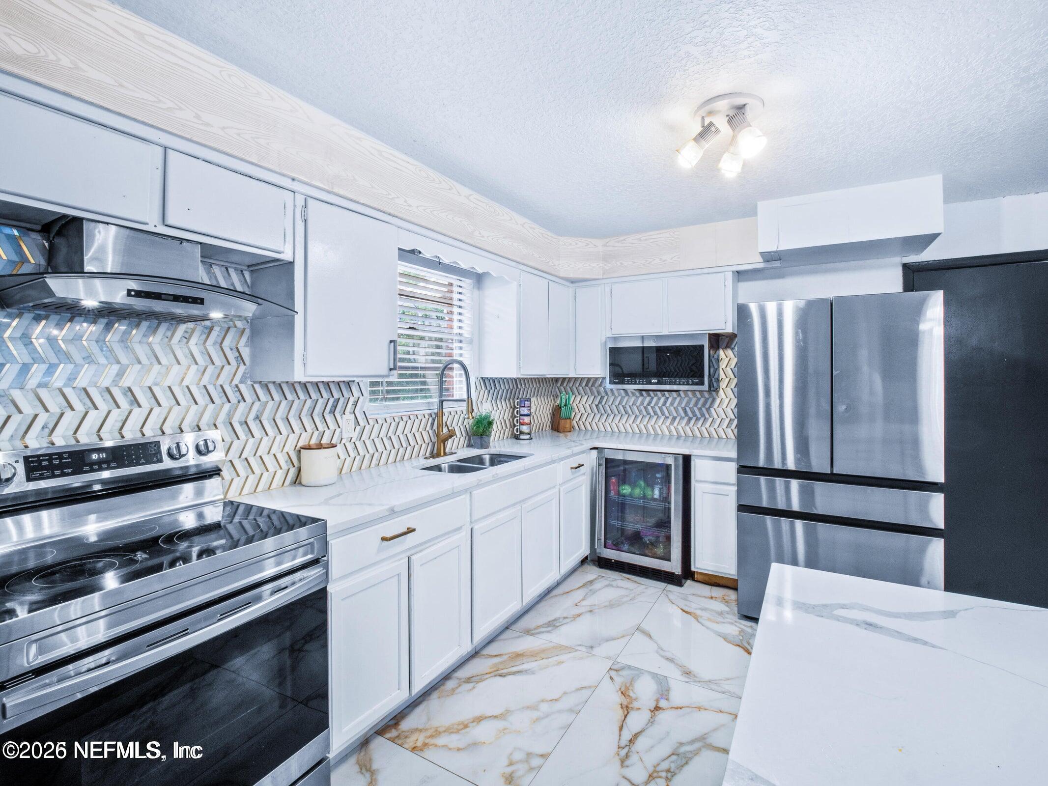 856 Palermo Road Jacksonville, FL 32216 - Photo 6 of 17 a kitchen with a stove top oven and refrigerator