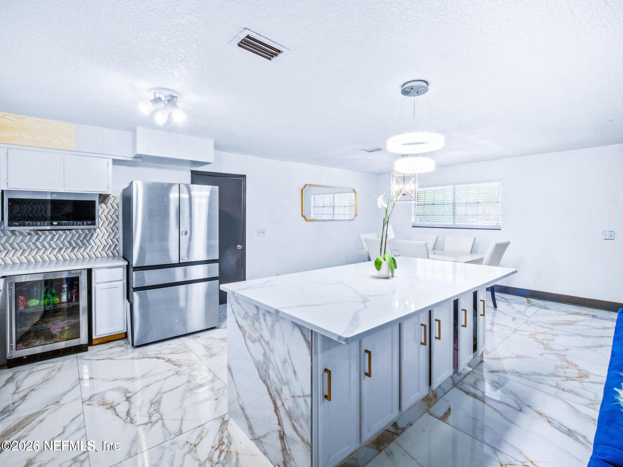 856 Palermo Road Jacksonville, FL 32216 - Photo 7 of 17 a kitchen with a stove a refrigerator and a fireplace