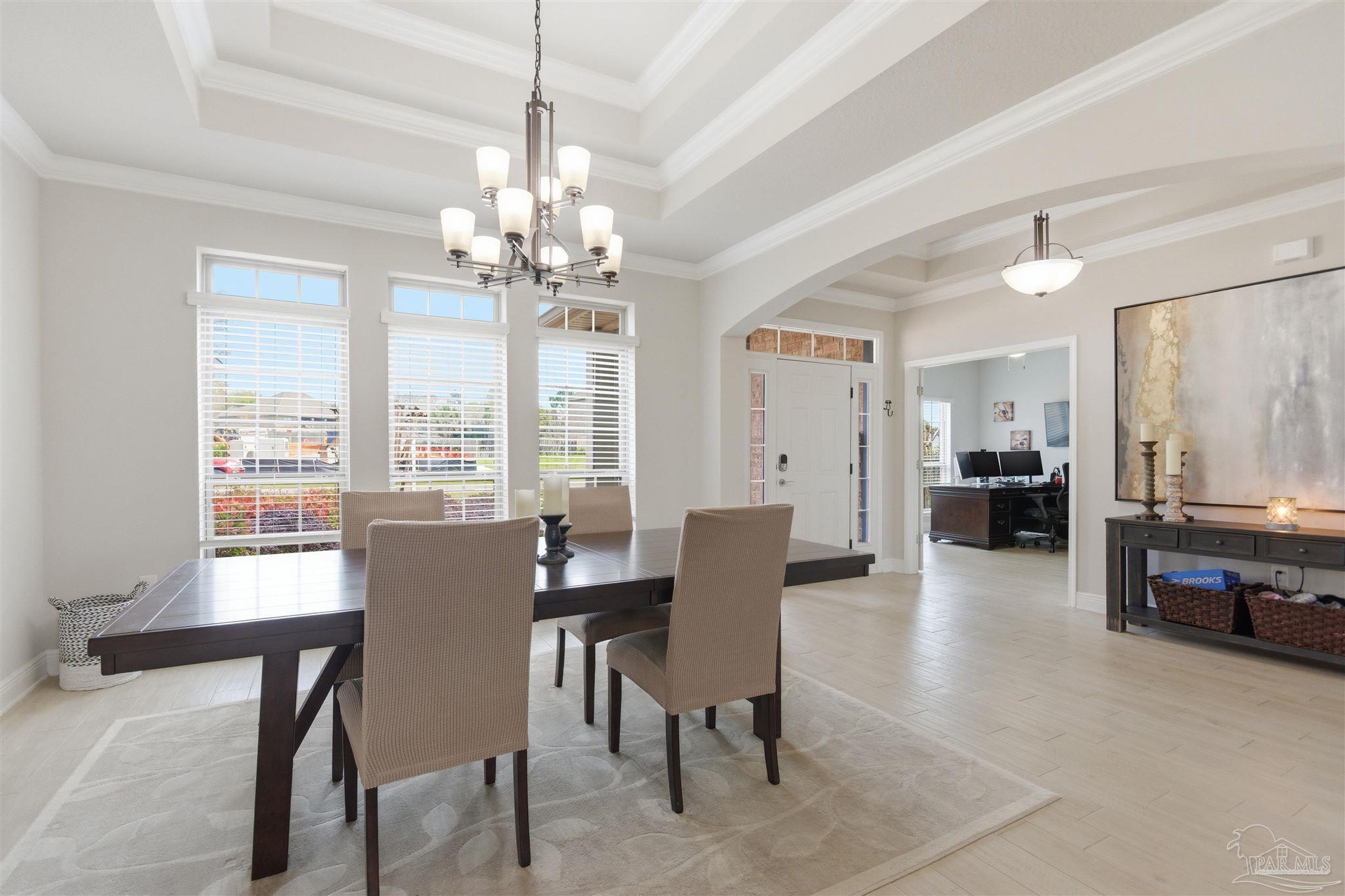 2677 Tulip Hill Road Pace, FL 32571 - Photo 5 of 35 a view of a dining room with furniture window and wooden floor