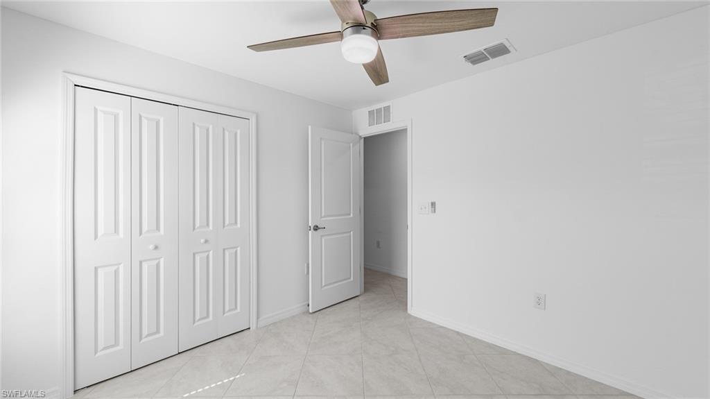 4016 4th Street West Lehigh Acres, FL 33971 - Photo 14 of 26 an empty room with windows and fan